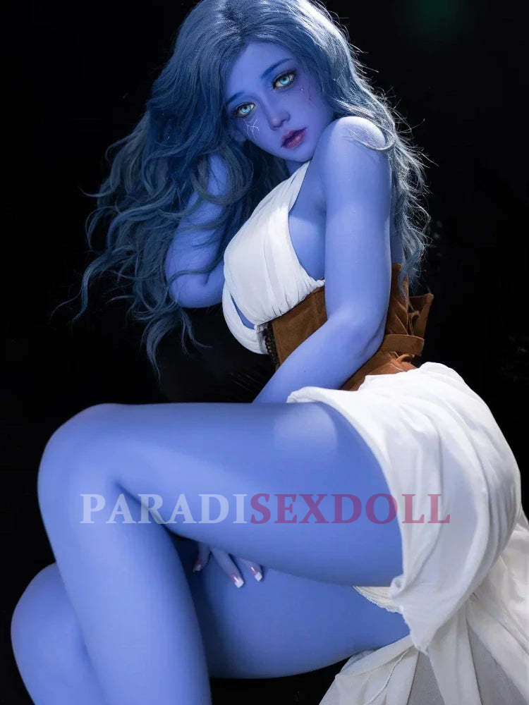 Chubby blue alien sex doll with long wavy light blue hair and striking green eyes, wearing a flowing white dress and brown corset, posed seductively against a dark background.