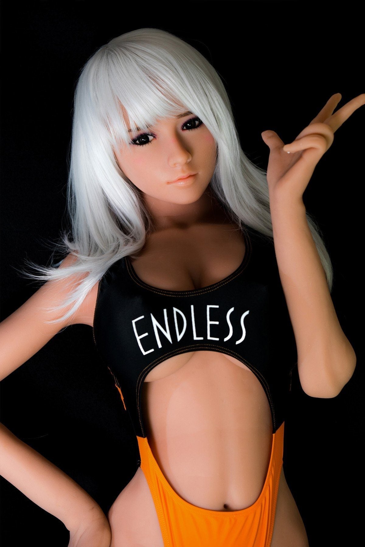 170cm Asian sex doll with K-Cup breasts, featuring long white hair and wearing a black swimsuit with orange accents that reads 'ENDLESS.' The doll strikes a flirty pose against a black background, showcasing its lifelike details and craftsmanship.