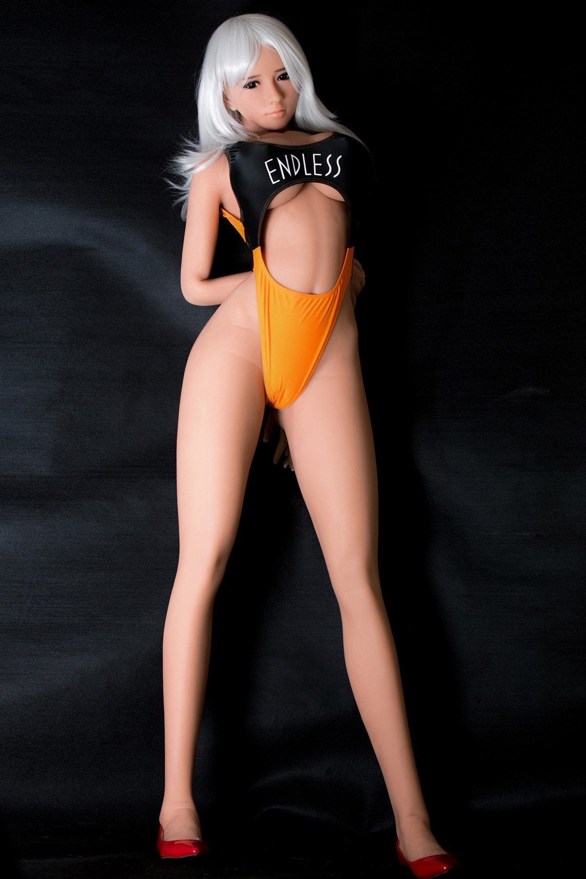 170cm Asian sex doll with K-Cup breasts in a black and orange swimsuit displaying the word 'ENDLESS'. The doll features long white hair and strikes a confident, seductive pose against a dark background, emphasizing its lifelike craftsmanship and realistic details.