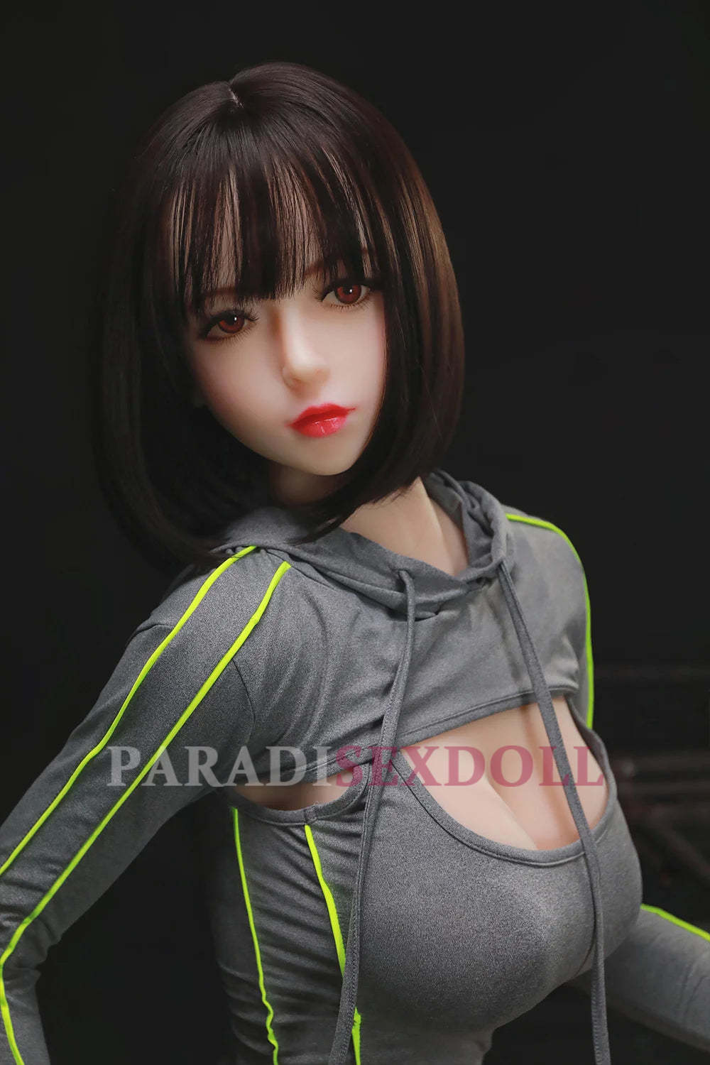 168cm exotic sex doll Olivia in a fitted grey sporty hoodie with neon accents, showcasing her voluptuous figure and realistic facial features, posing confidently.