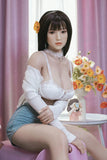 Full-size silicone realistic sex doll in white lingerie with natural color and Asian features sitting on stool