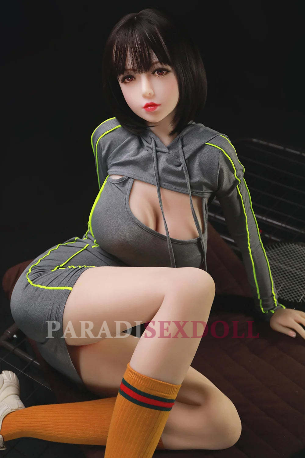 168cm exotic sex doll Olivia wearing a sporty grey and neon outfit with prominent cleavage, showcasing her Asian beauty and athletic figure.