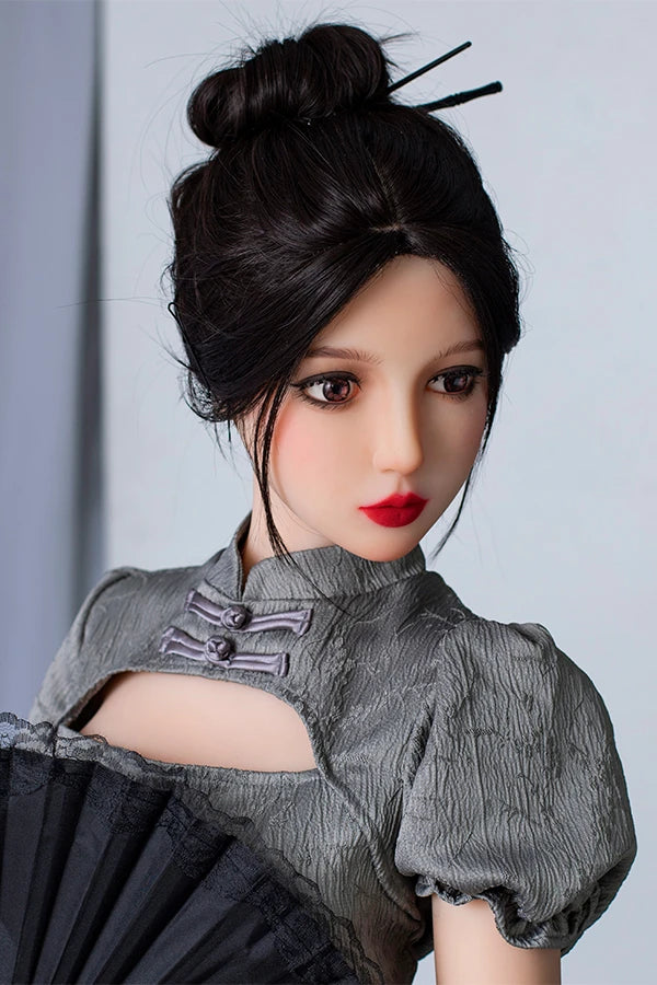 Lifesize Chinese sex doll named Winni, elegantly posed with a black lace fan, wearing a stylish gray puff-sleeve dress, featuring an intricate hairstyle with decorative hair sticks against a neutral background.