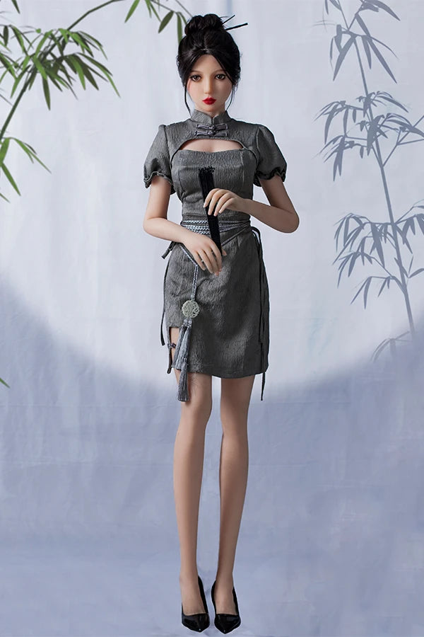 Sophisticated lifesize Chinese sex doll Winni elegantly dressed in a gray puff-sleeve dress holding a black fan, seated on a pedestal with a gentle bamboo-patterned background.