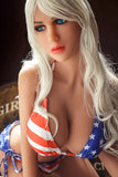 Avianna American beauty love doll in a striking red, white, and blue bikini, featuring a patriotic design with stars and stripes, highlighted by long blonde hair and blue eyes, posing elegantly.