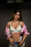 158cm/5ft2 TPE sex doll with long brown hair, wearing a white crop top and a stylish pink jacket, showcasing her impressive bust and fashionable appearance, highlighted by the chic styling of her denim shorts.